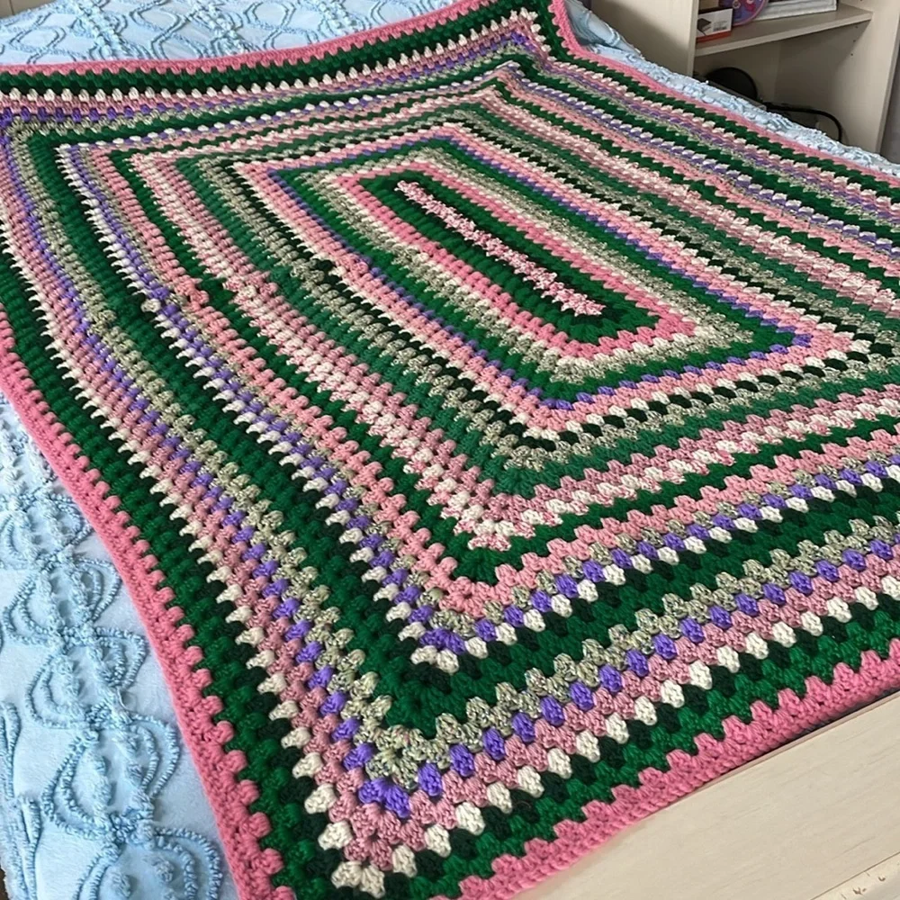 Knitted afghan /throw vintage item greens/pinks with a hint of purple